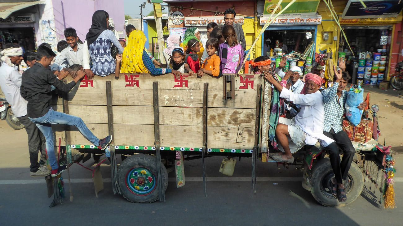 Passengers on a wagon in the streets of Delhi