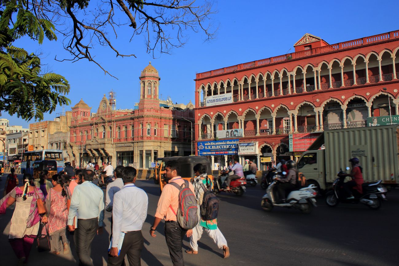 Pedestrians and traffic make their way past the architectural gems of Mount Road in Chennai