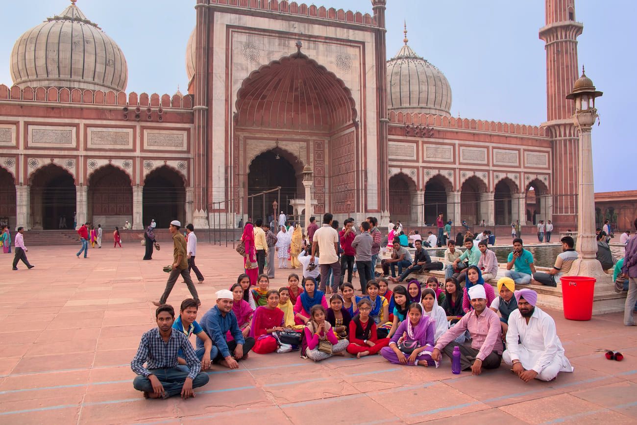 People sitting at the Jama Masjid, Delhi, India. The mosque’s courtyard can accommodate up to twenty-five worshippers 