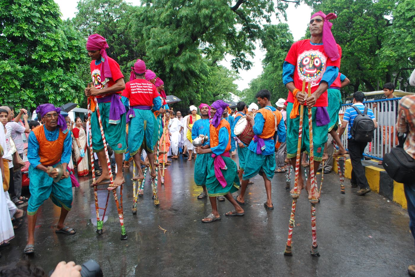 People watch colorful procession of performers during the week-long Rathyatra Festival in Kolkata