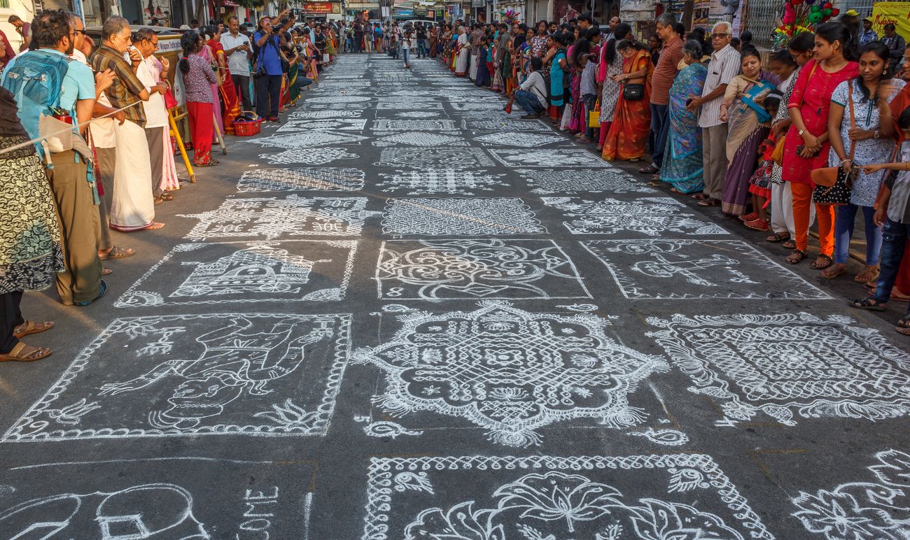 Kolam or Rangoli is the Indian tradition of covering streets in intricate, lace-like drawings using colored or white rice, usually during Hindu festivals