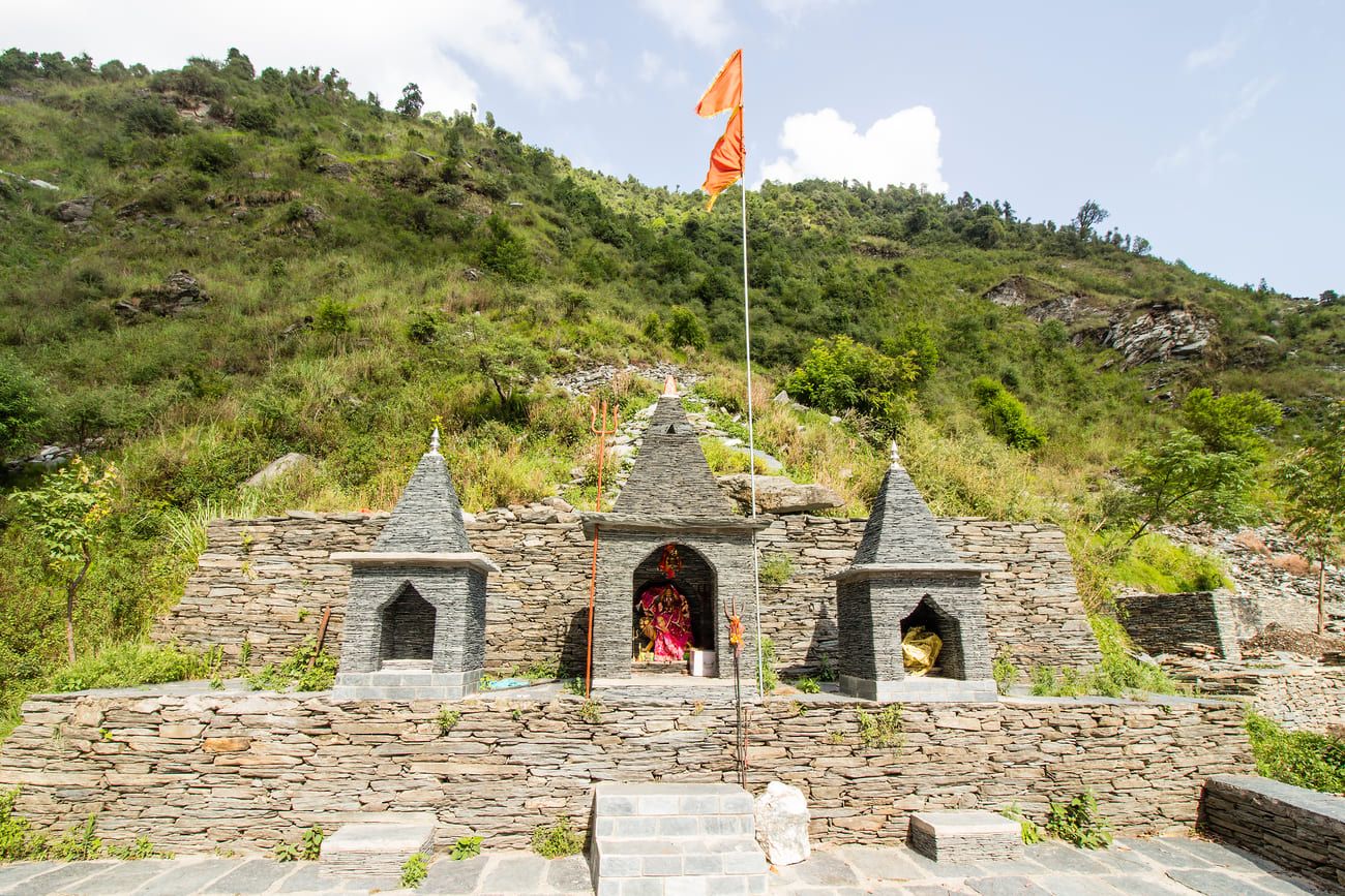 Small stone shrine in the mountains near Bhagsu Waterfall in Himachal Pradesh