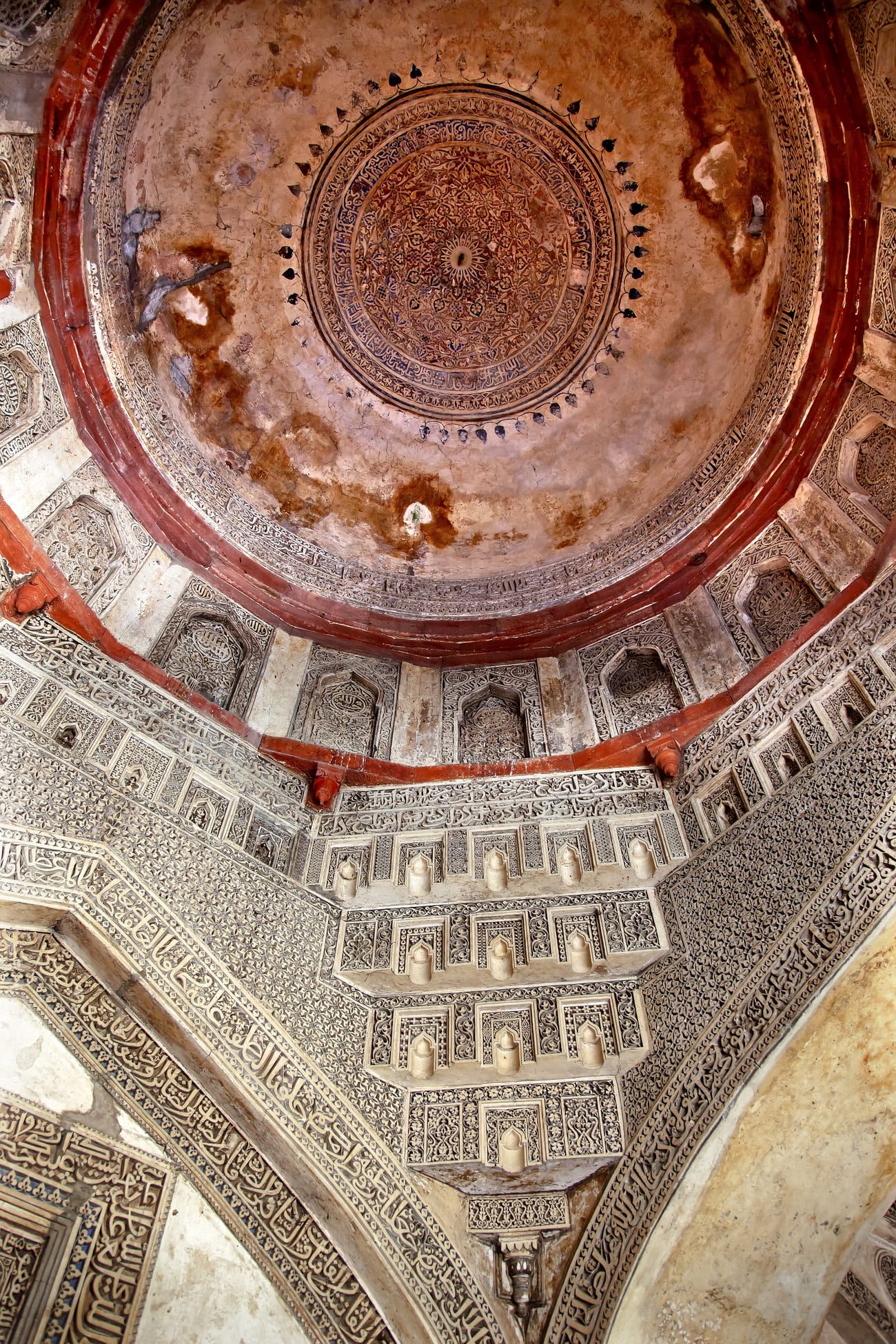 The richly decorated ancient dome inside the huge Sheesh Shish Gumbad Tomb at Lodi Gardens in New Delhi, India