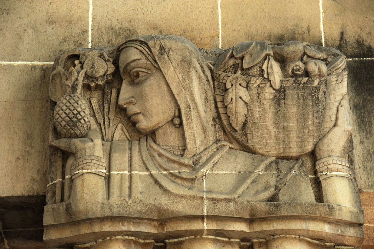 The stone carved sculpture dubbed "Lady with Fruit Basket” outside the landmark building of the New India Assurance building which is a fusion of Indian and European architectural styles