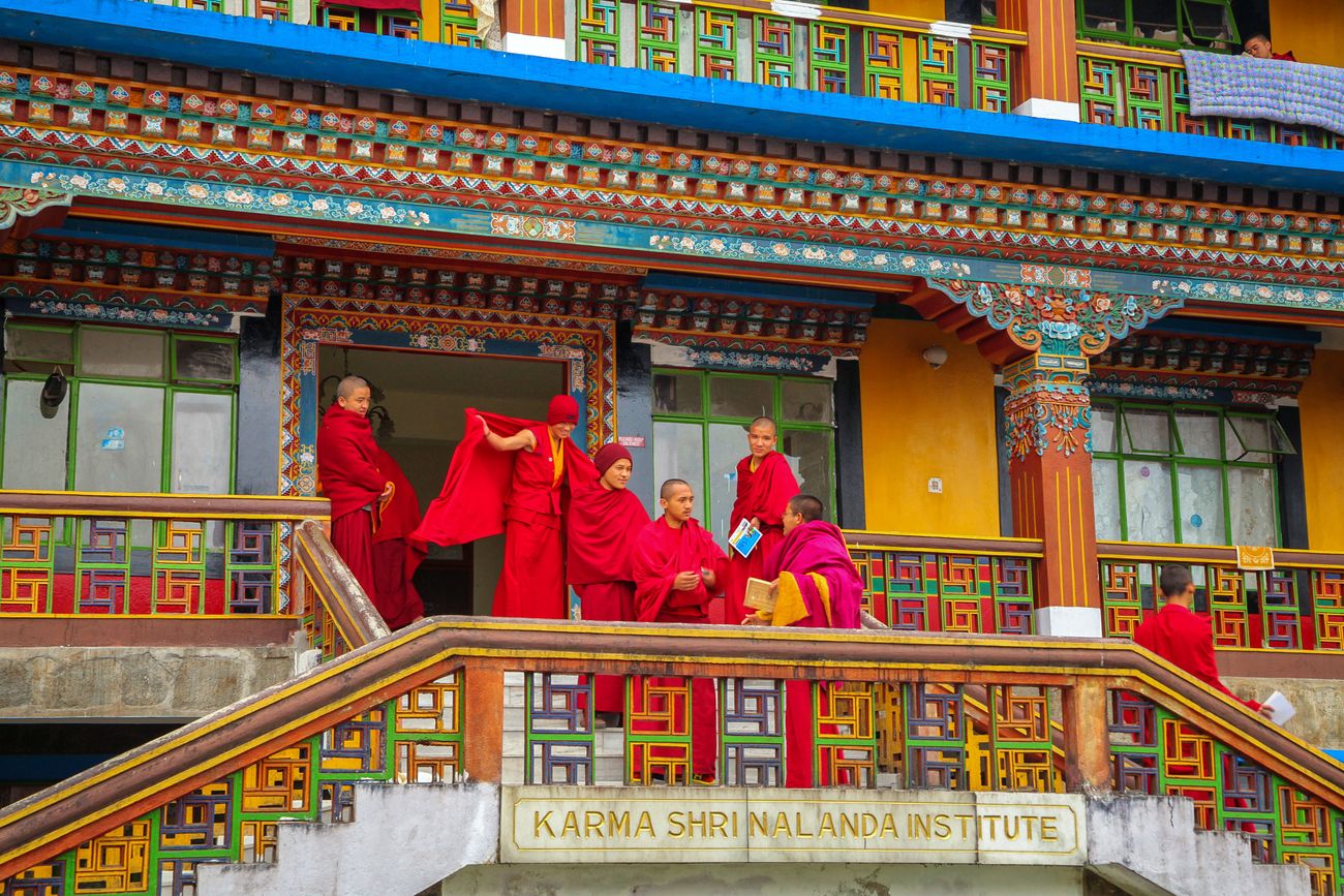 Tibetian monks stand outside the vibrant Rumtek Monastery which is one of the most famous monuments of Gangtok