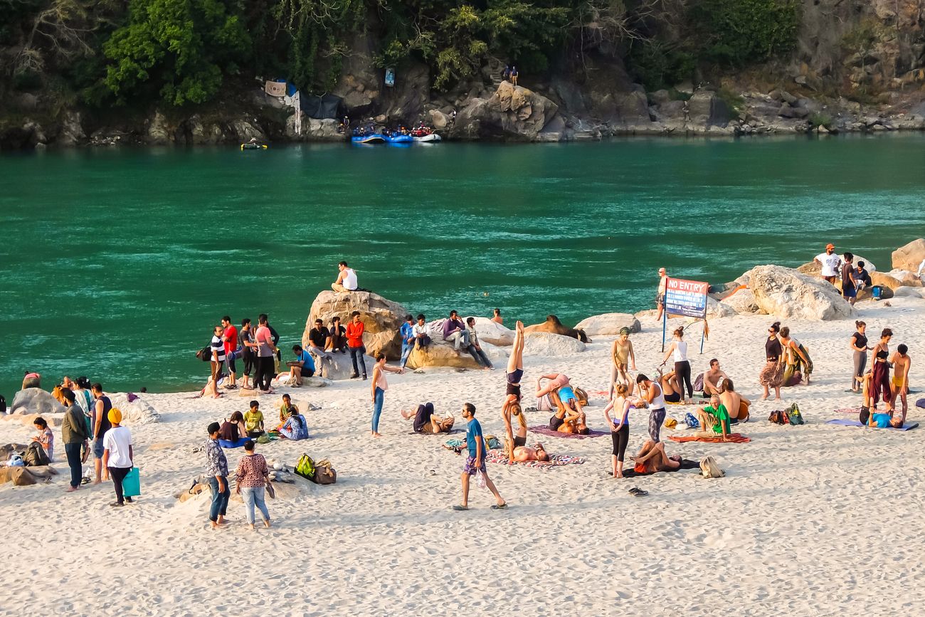 Tourists crowd around the banks of river Ganga in Rishikesh, Uttarakhand, enjoying the pristine waters and the lovely view amidst the valley. Parmarth Niketan in Rishikesh is one of the more reputed yoga institutions in India 