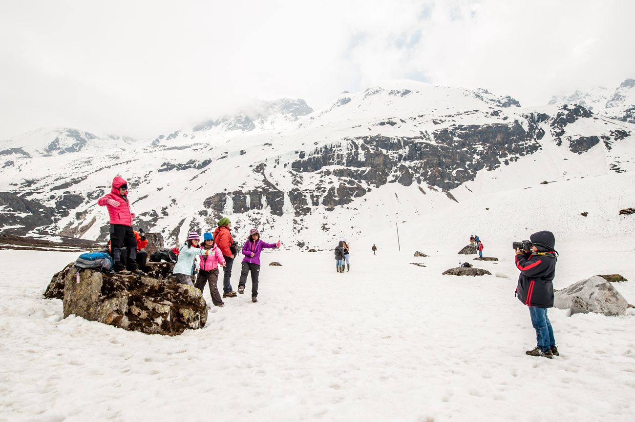 Tourists play and snap pictures in the fresh snow of the Yumthang Valley at Zero Point which is to the end of the road