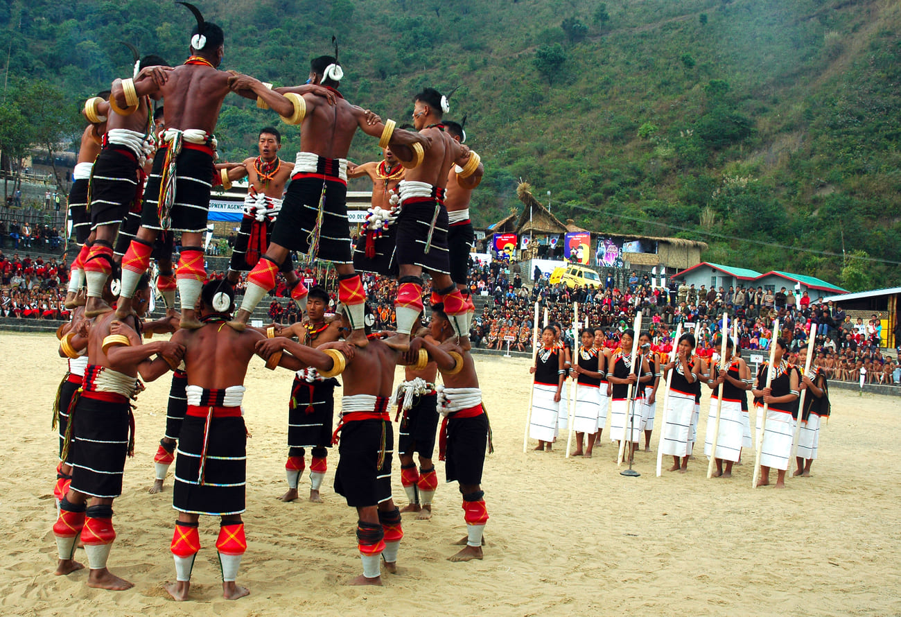 Tribesmen building a human pyramid to demonstrate their skill