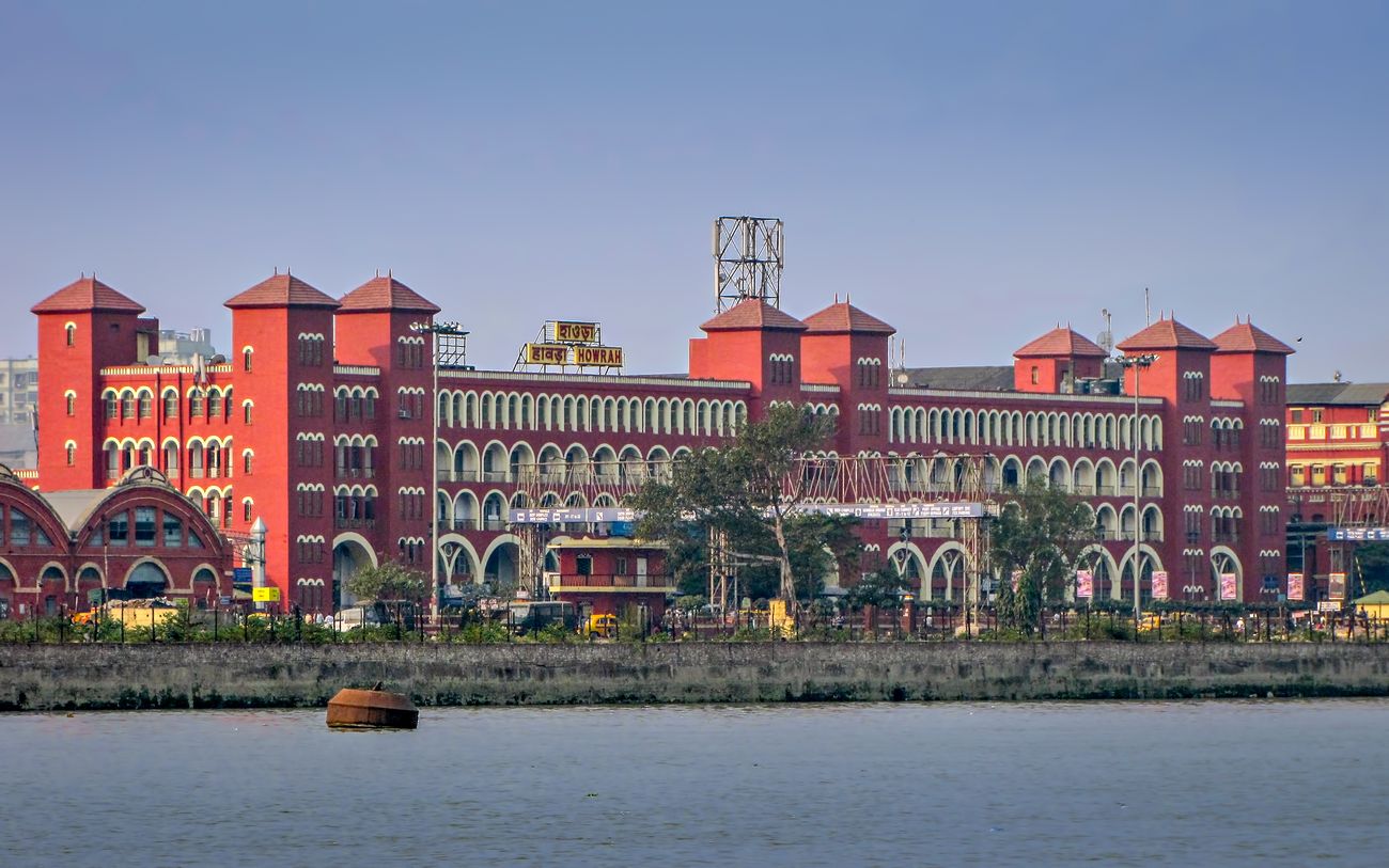 View of the Howrah Railway Station, the oldest and largest railway complex in India, across Hooghly river in Kolkata, West Bengal, India 