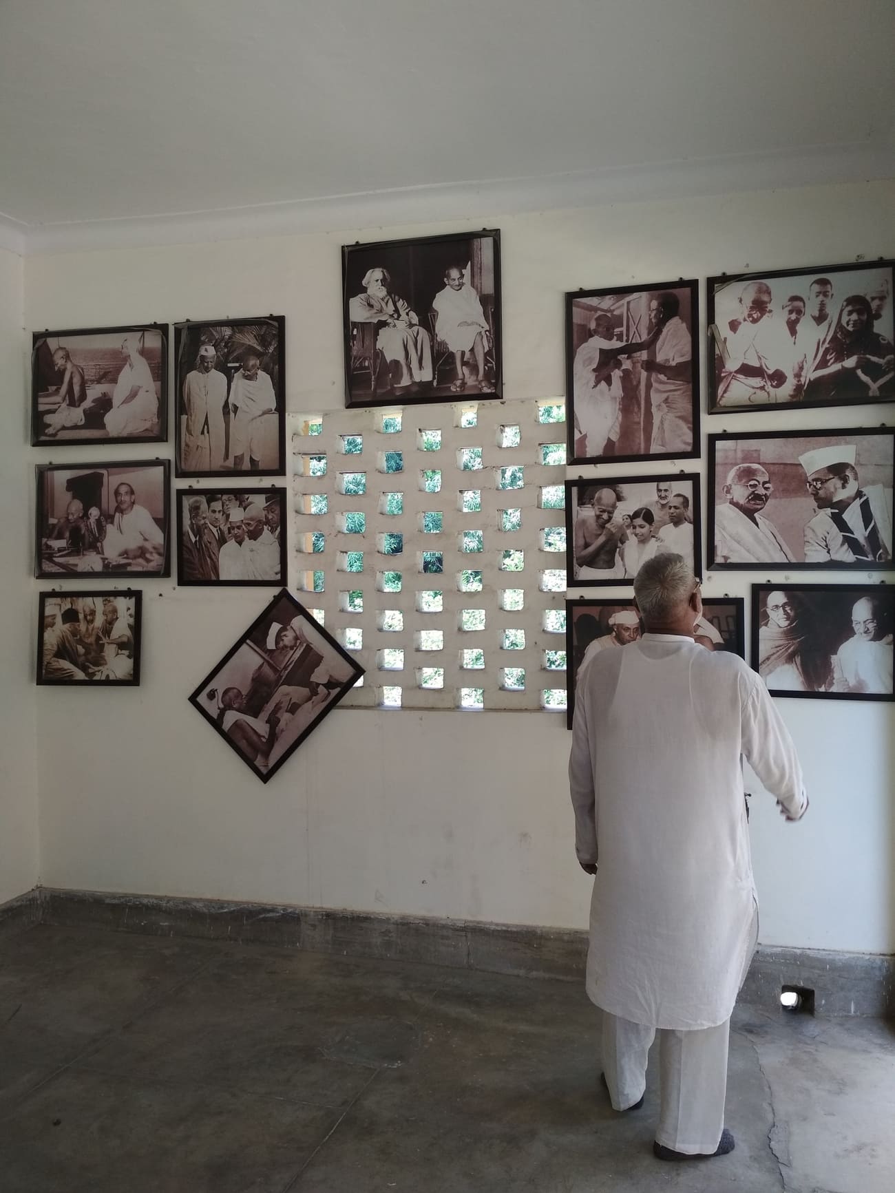 Visitor looking at the pictures of Pandit Nehru with other leaders in the Mahatma Gandhi room, Delhi