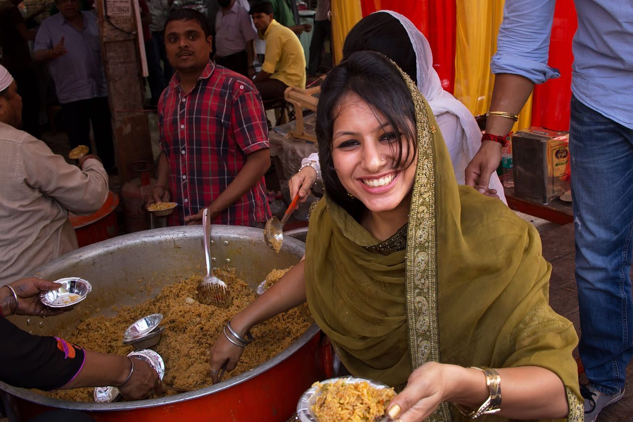 Woman dishing out rice during Guru Nanak Gurpurab celebration in Delhi, India. The festival celebrates the birth of the first Sikh Guru