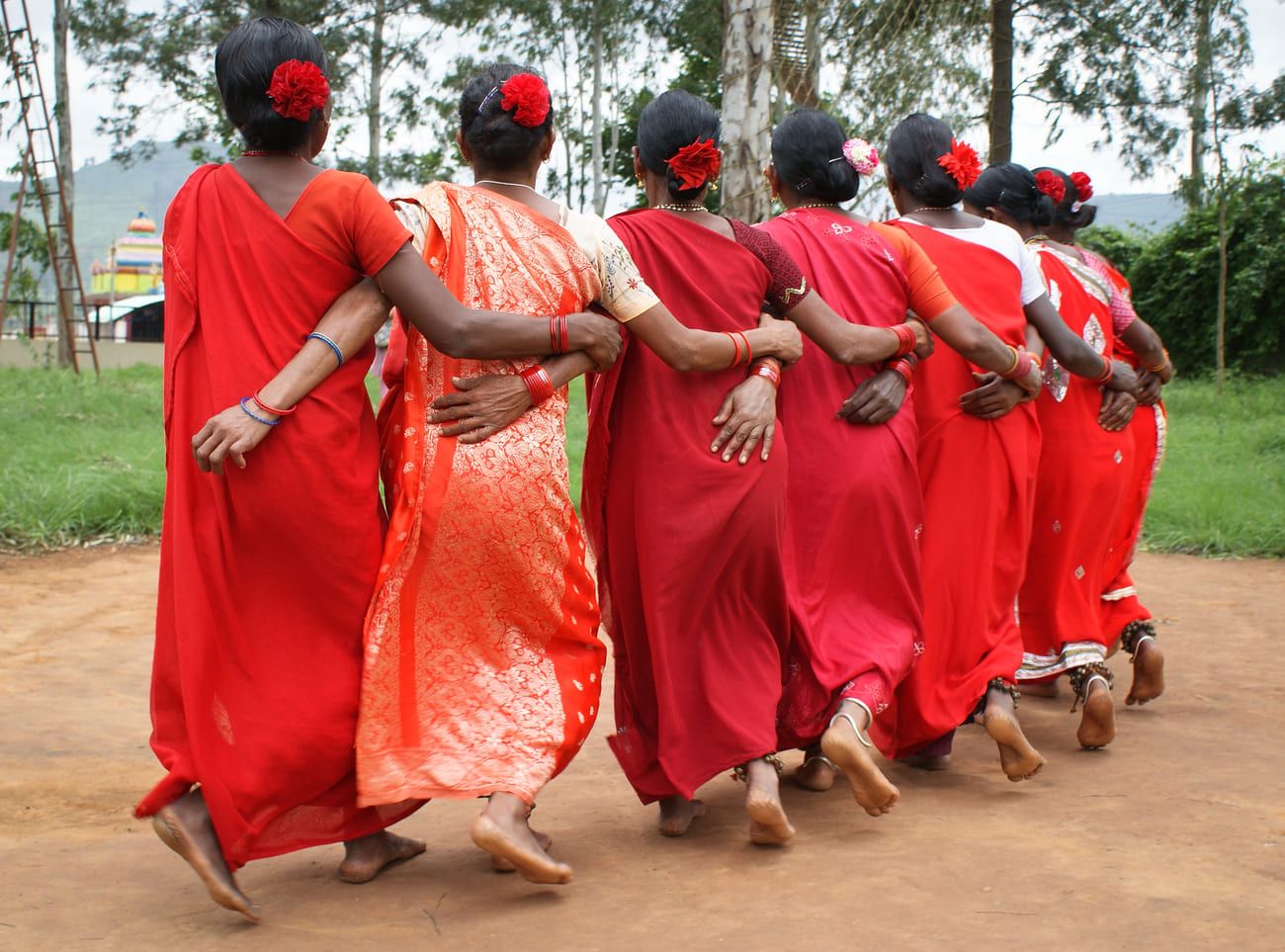 Women dressed in shades of red perform the traditional Porja tribal dance called dhimsa