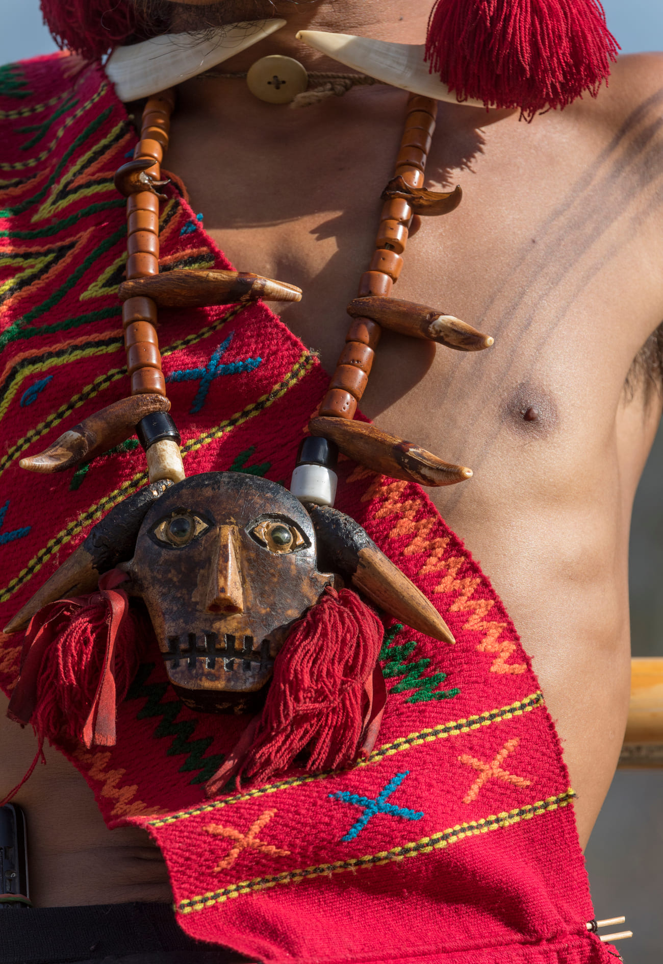 5.Traditional wood-carved Naga necklace worn during the Hornbill Festival Different materials are used to fashion the jewelry and headgear, like beads, wood, feathers etc