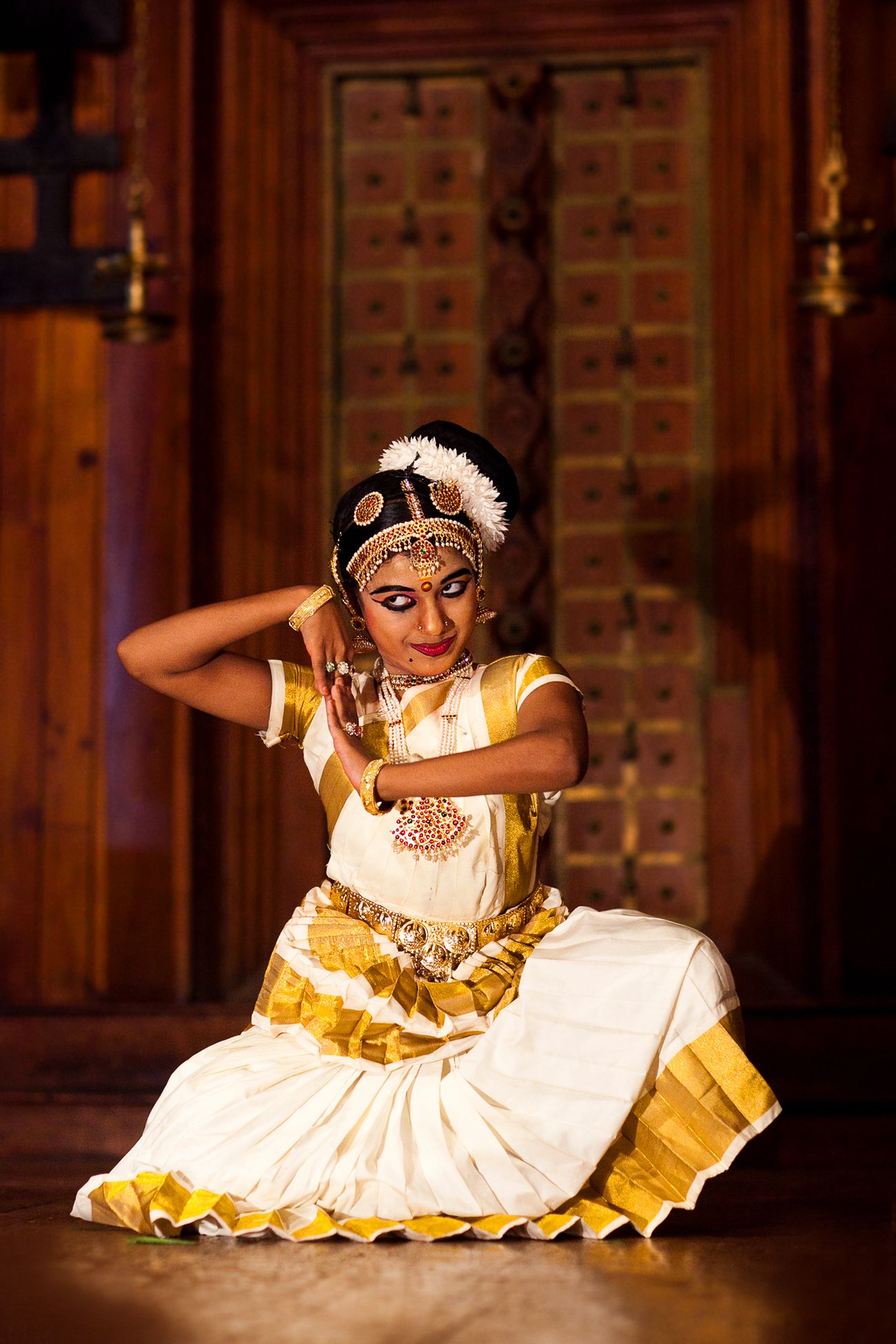 Young female dancer performing Mohiniyattam, or the dance of enchantress, a traditional South Indian dance form at Fort Kochi in Kerala