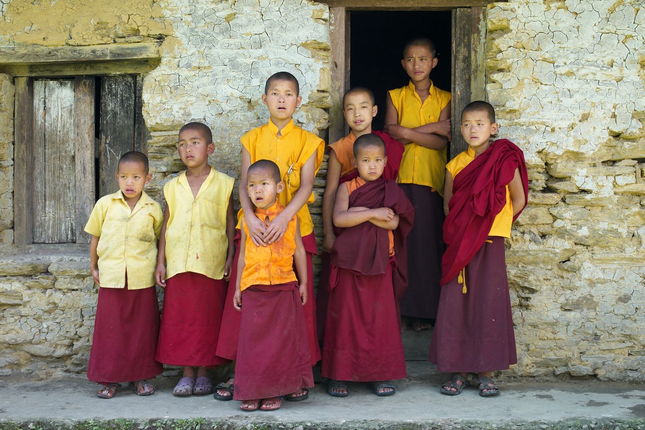 Young monks stand outside a house in Sangachoeling Gompa in Sikkim, which is a very popular monastery