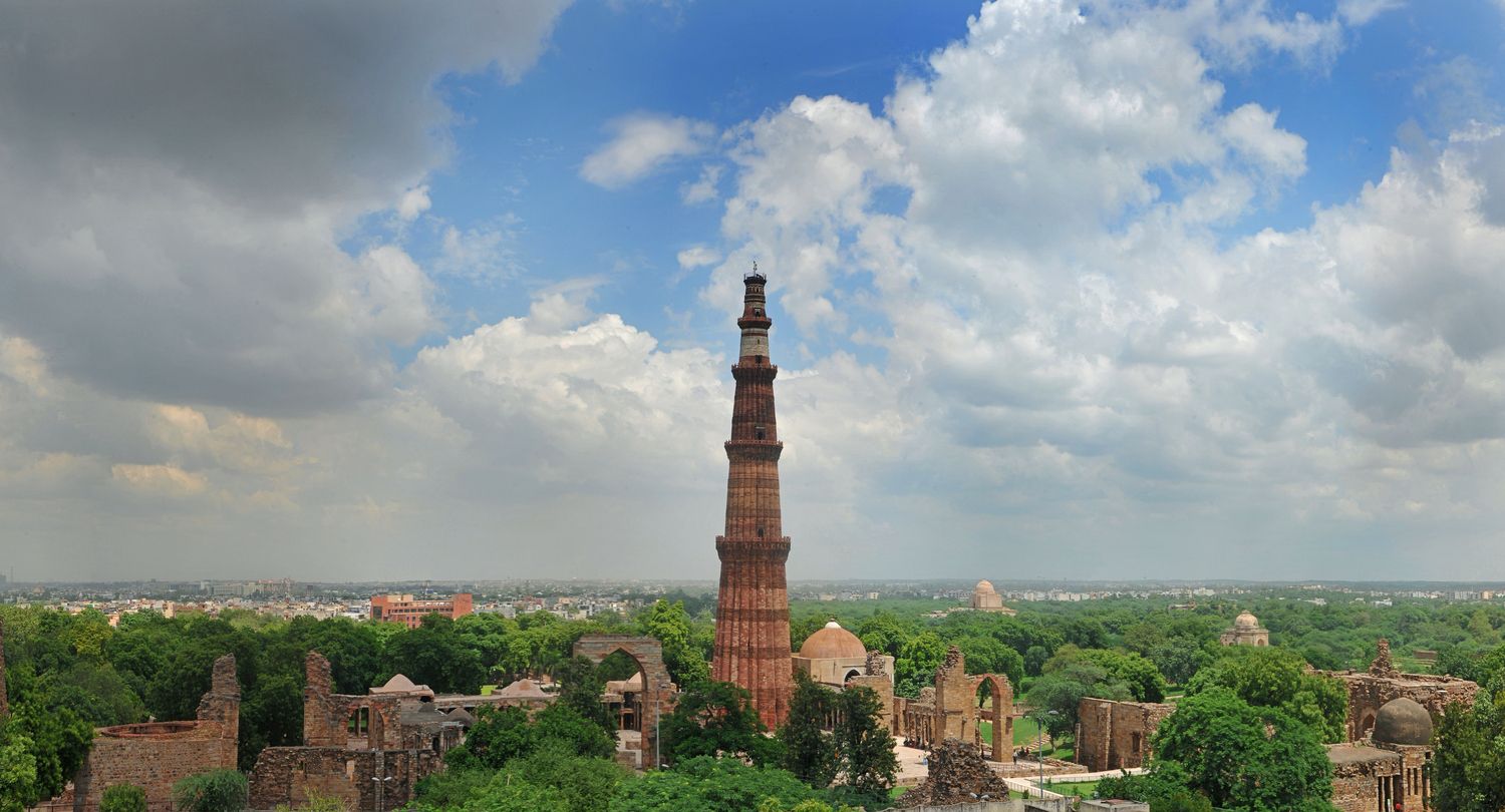 aerial view of qutub minar and surrounding monuments in mehrauli archaeological park