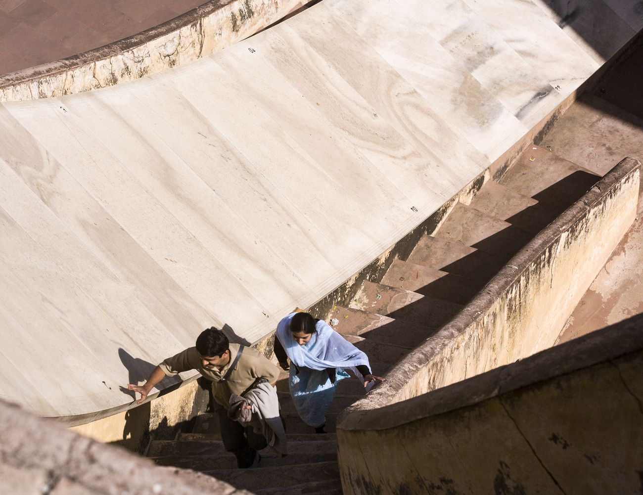 Local visitors scale the steps next to the Vrihat Samrat Yantra