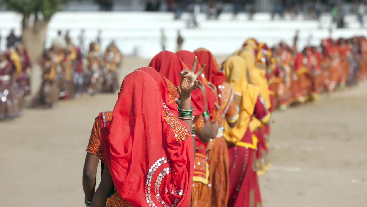 An group of unidentified girls in colorful ethnic attire attends at the Pushkar fair