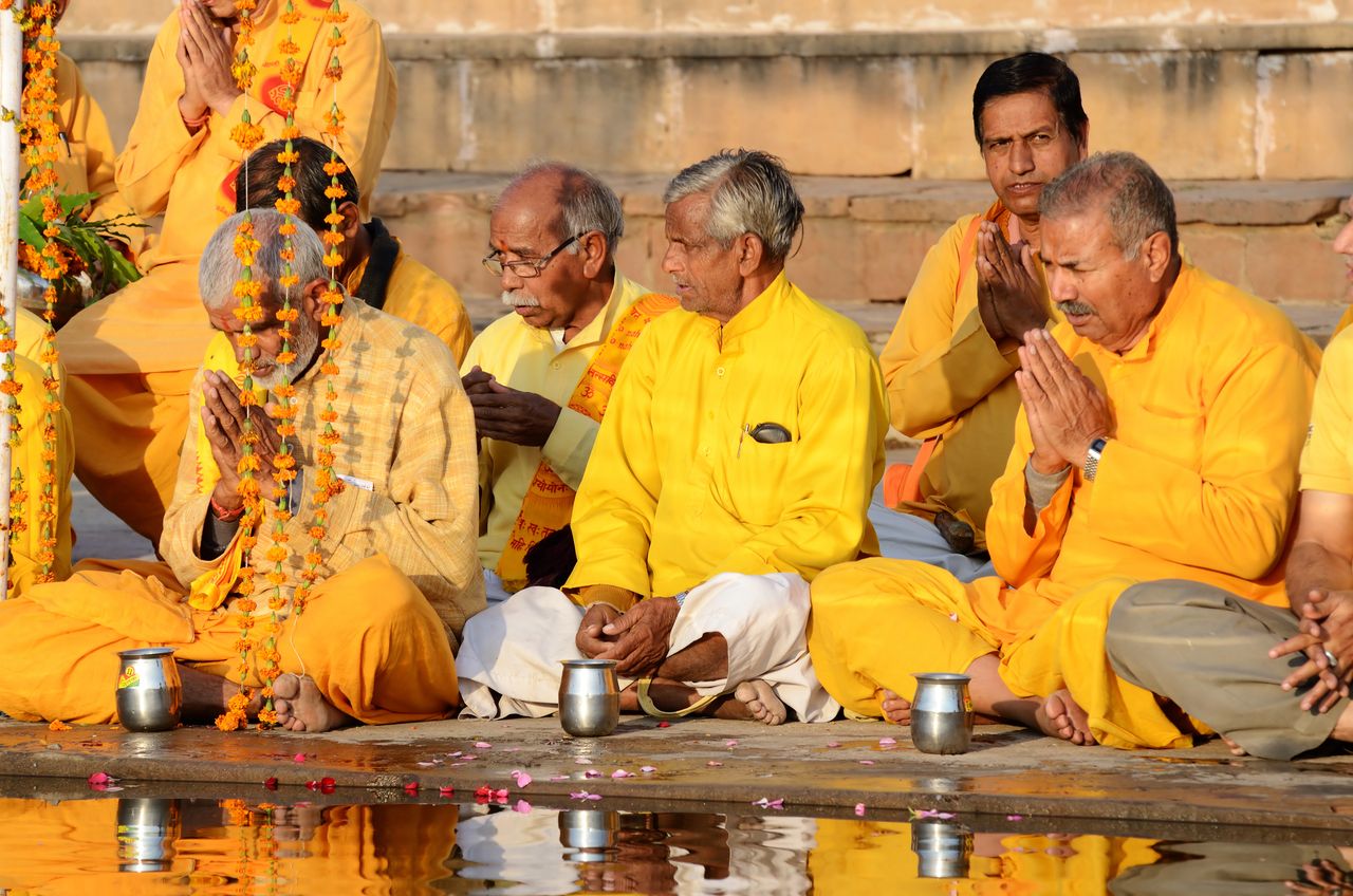 Senior men perform puja - ritual ceremony at holy Pushkar