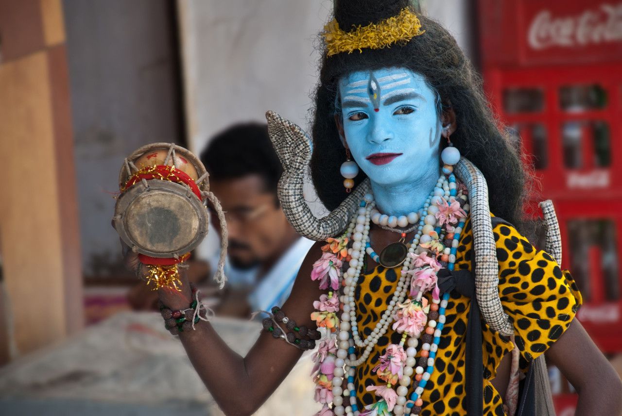 young man performing on the street dressed up like god shiva during pushkar fair