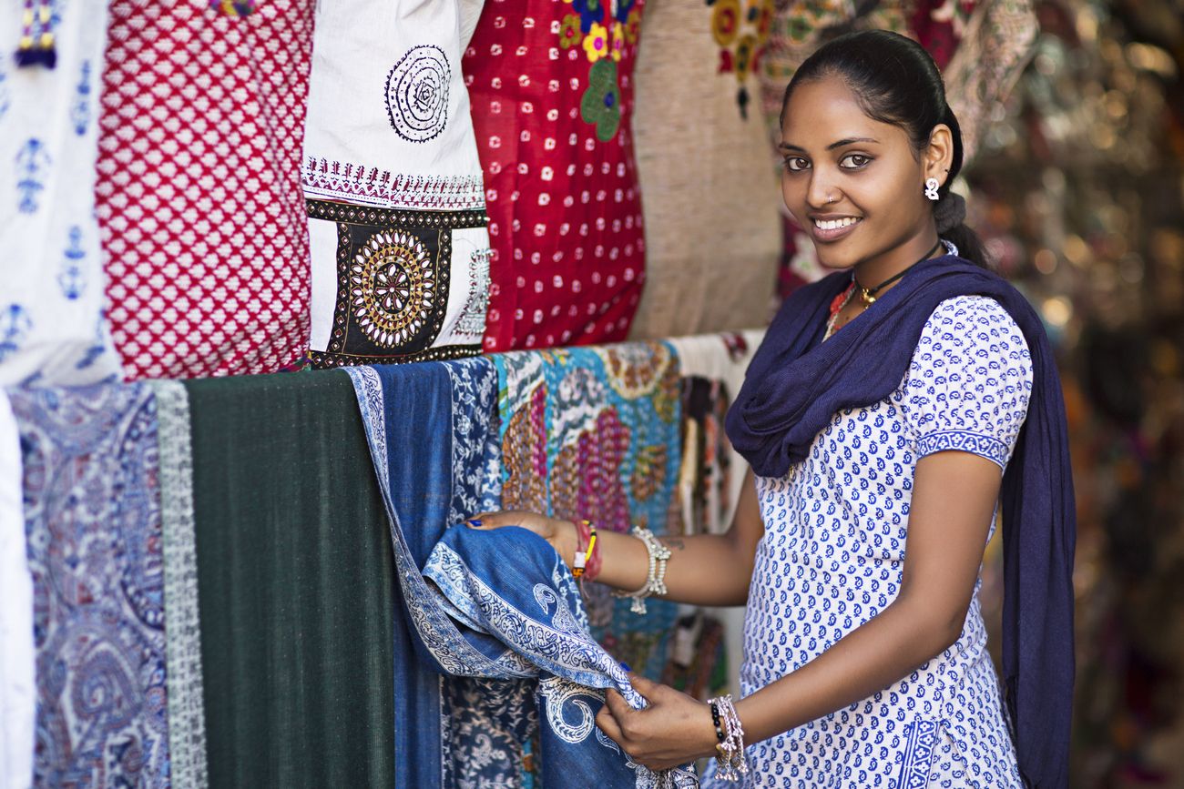 sales girl showing textile in jaipur shop