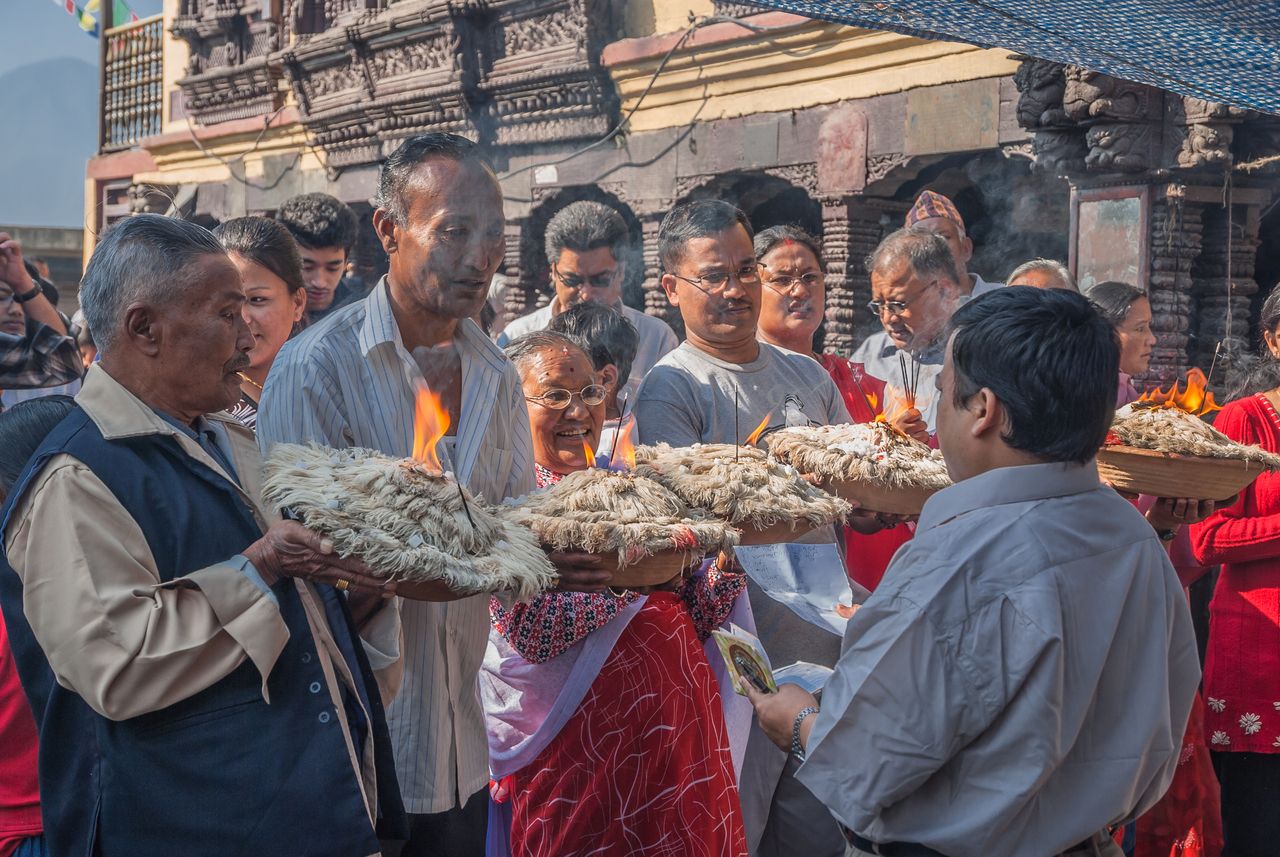 people stand in line buddhist temple swaymbhunath kaathmandu