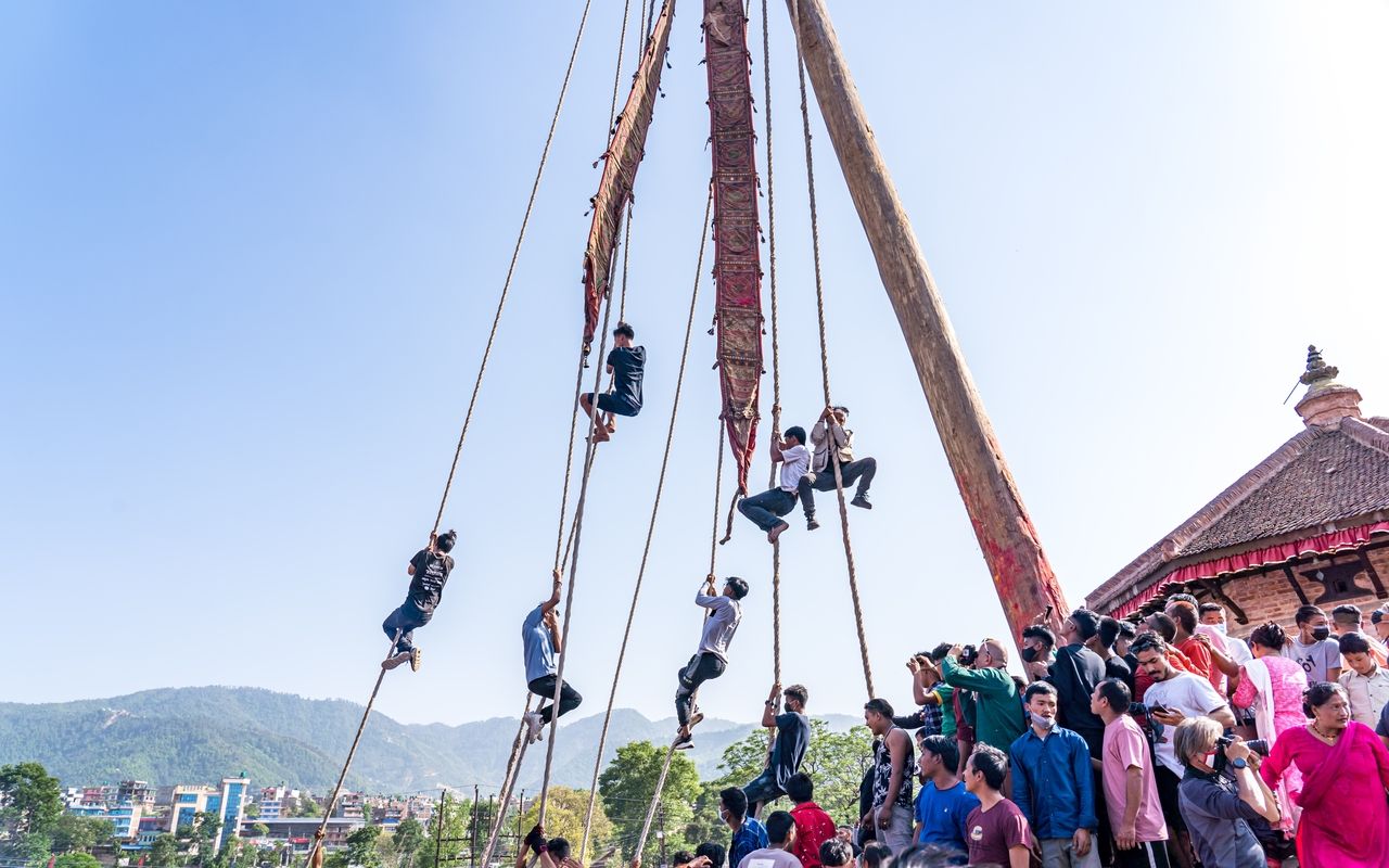 people climbing rope on pole in biska festival Bhaktapur
