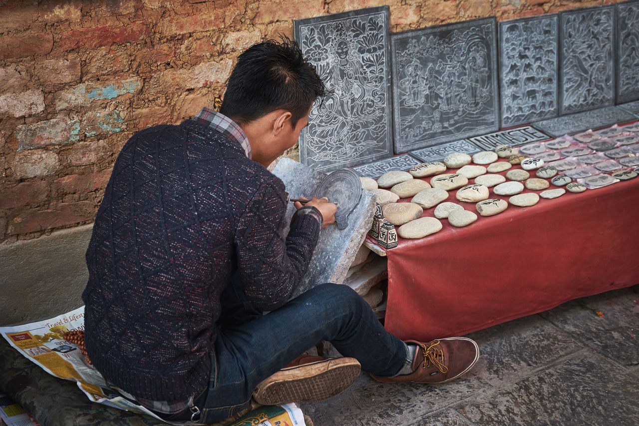 Nepalese stone carver working Swayambhunath temple