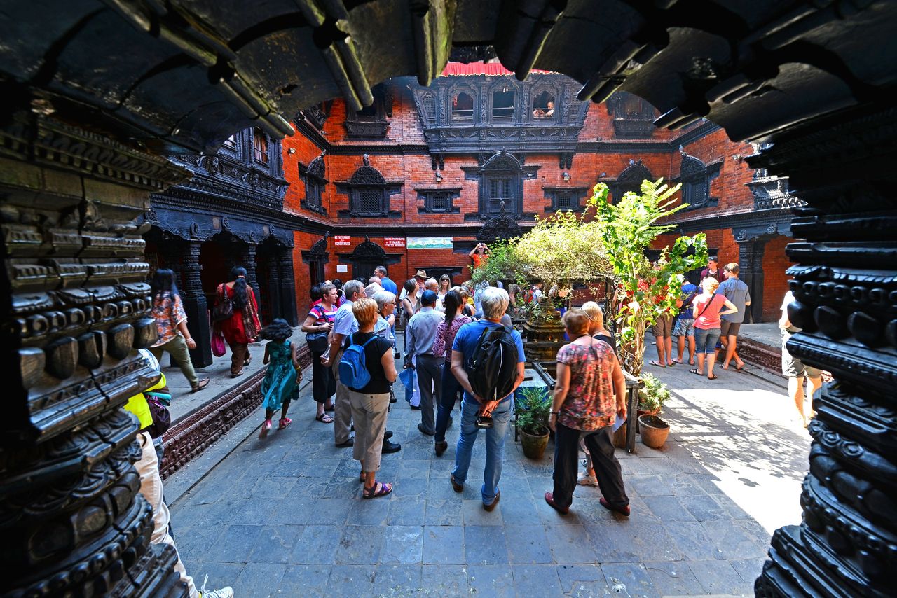 Visitors admire the beautiful inner courtyard of the Kumari Palace